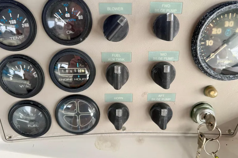 Slide: The Image of Control panel of a 1997 Carver 355 Aft Cabin Motor Yacht with gauges and switches. - 14