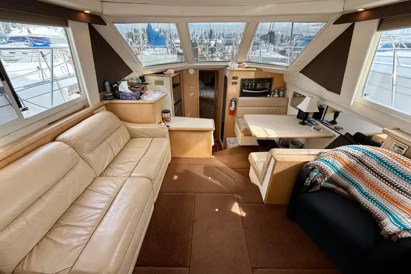 Slide: The Image of Interior of 1997 Carver 355 Aft Cabin Motor Yacht with beige seating and dining area. - 20