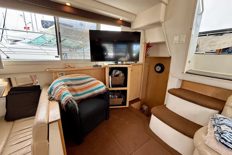 Slide: The Image of Interior of 1997 Carver 355 Aft Cabin Motor Yacht with cozy seating and TV. - 22