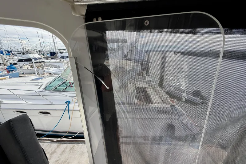 Slide: The Image of 1997 Carver 355 Aft Cabin Motor Yacht docked at marina, view through cabin window. - 36