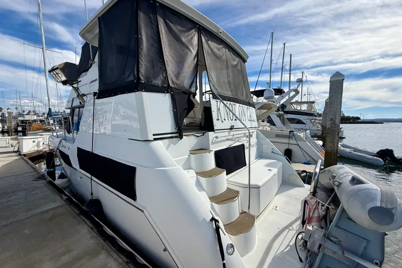 Slide: The Image of 1997 Carver 355 Aft Cabin Motor Yacht docked at marina, featuring spacious aft deck. - 5