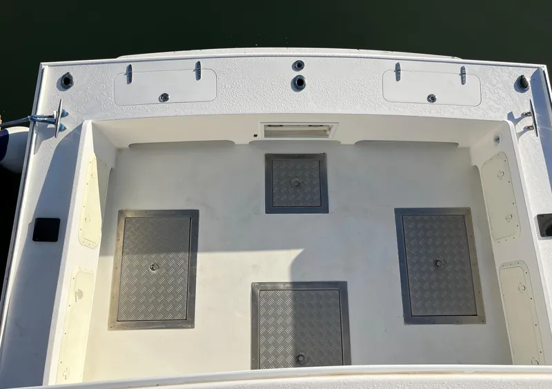 Slide: The Image of 2001 Northern Bay 36 boat deck with storage hatches and clean white surface. - 10