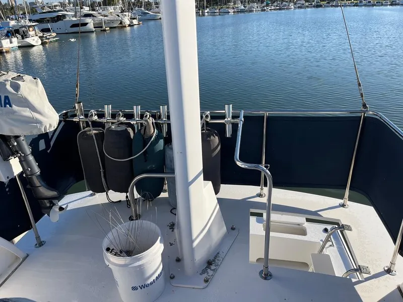 Slide: The Image of Northern Bay 36 boat deck, 2001 model, docked at marina with fishing gear. - 11