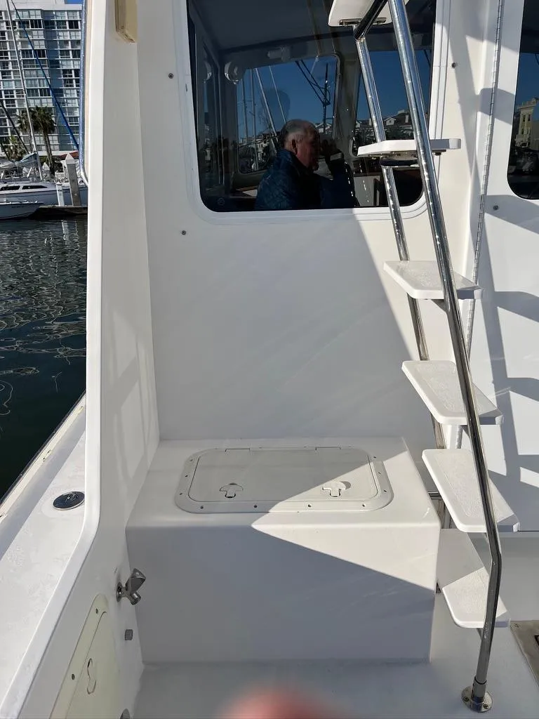 Slide: The Image of 2001 Northern Bay 36 boat with white exterior and ladder, docked at marina. - 13