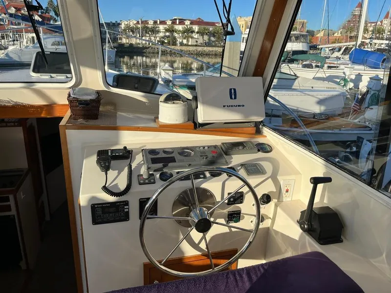 Slide: The Image of Helm of 2001 Northern Bay 36 boat with steering wheel and navigation equipment. - 15