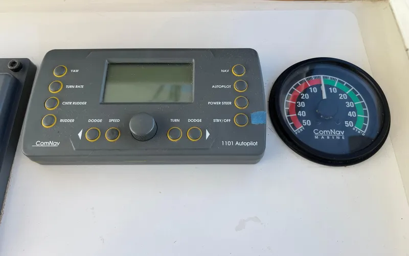 Slide: The Image of Control panel of a 2001 Northern Bay 36 boat with ComNav autopilot and gauge. - 18