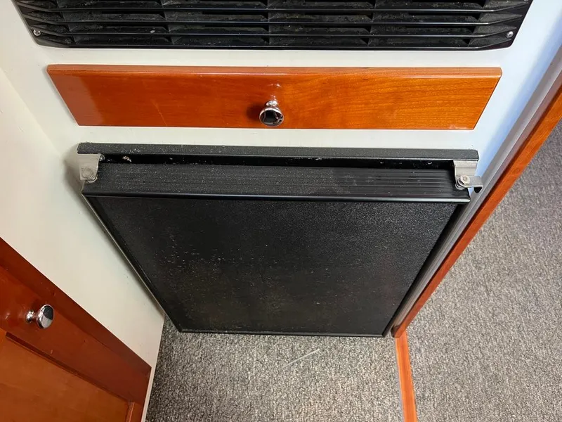 Slide: The Image of 2001 Northern Bay 36 interior with black panel and wooden drawer. - 28