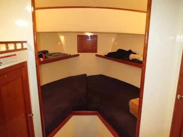 Slide: The Image of Interior cabin of 2001 Northern Bay 36 boat with cozy seating and wooden accents. - 29