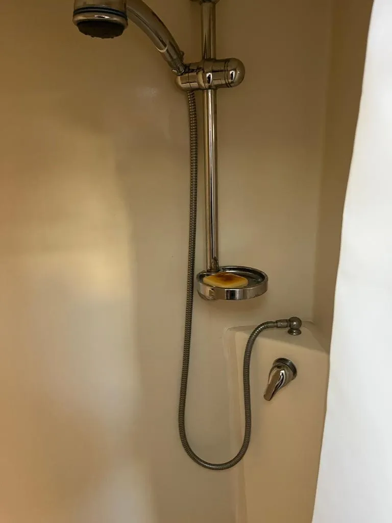 Slide: The Image of Shower area in a 2001 Northern Bay 36 boat, featuring a handheld showerhead. - 33