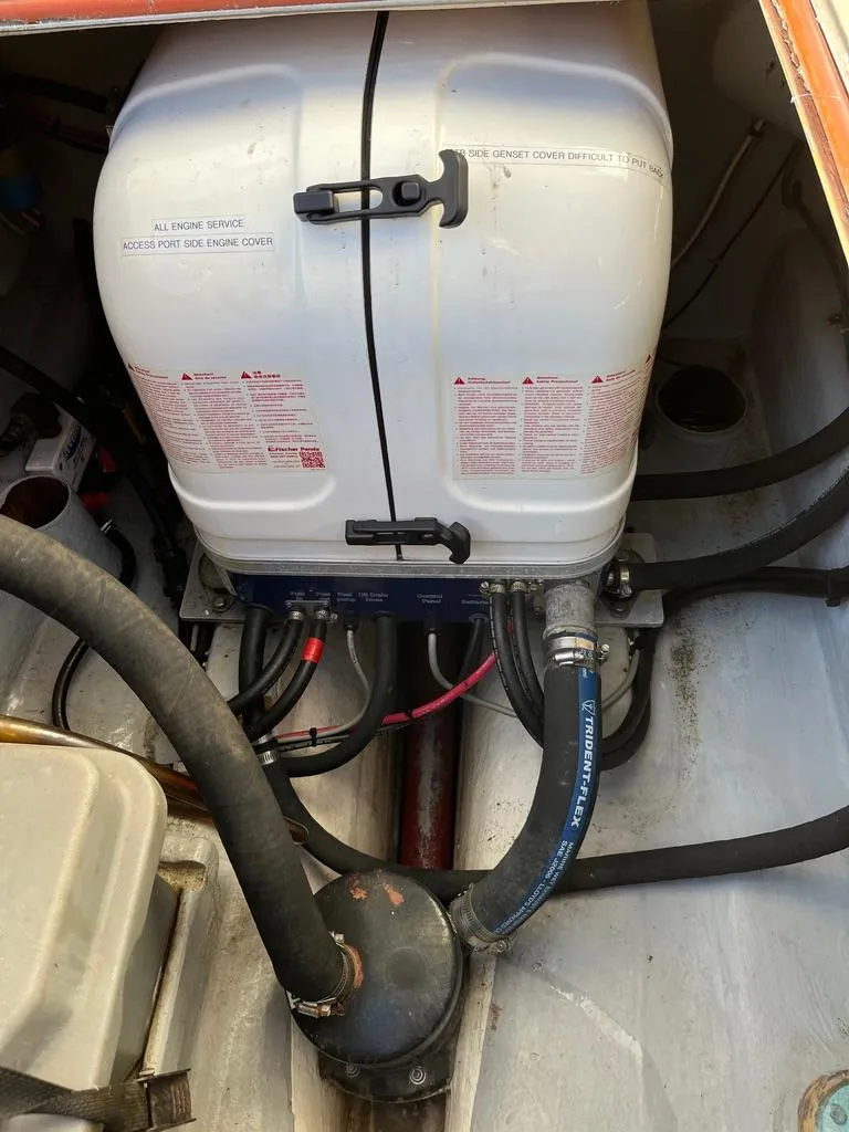 Slide: The Image of Engine compartment of a 2001 Northern Bay 36 boat, featuring hoses and equipment. - 37