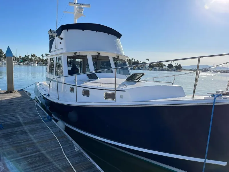 Slide: The Image of 2001 Northern Bay 36 boat docked by a sunny marina. - 4