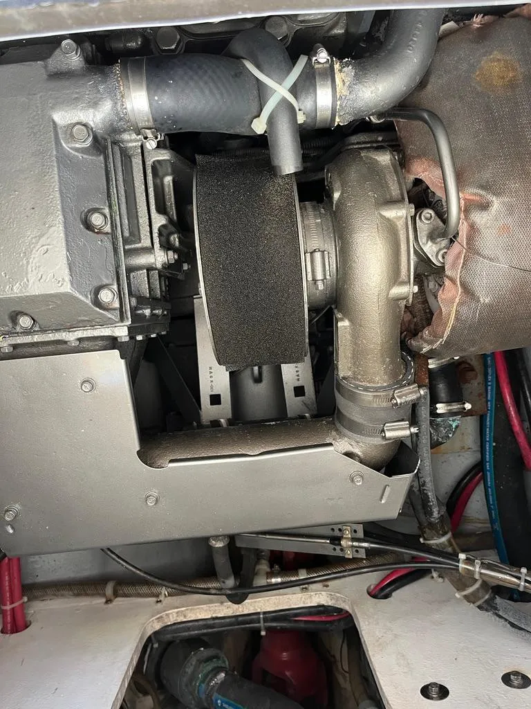 Slide: The Image of Engine compartment of a 2001 Northern Bay 36 boat, showcasing mechanical components and hoses. - 40