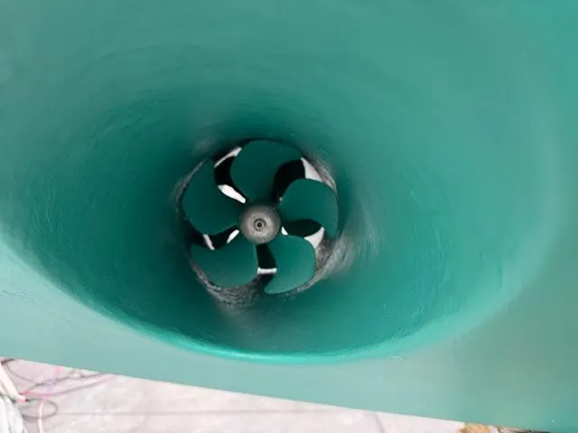 Slide: The Image of Bow thruster of a 2001 Northern Bay 36 boat, painted in teal. - 42