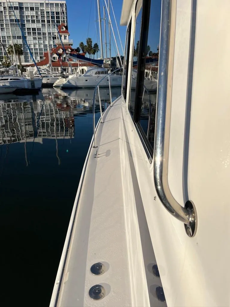 Slide: The Image of 2001 Northern Bay 36 boat docked in a marina with reflections on water. - 7