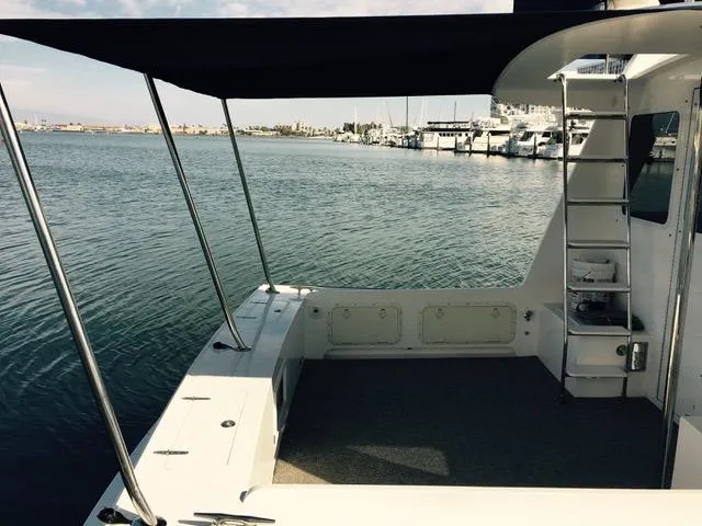 Slide: The Image of Northern Bay 36 boat, 2001 model, docked with shaded deck and marina view. - 9