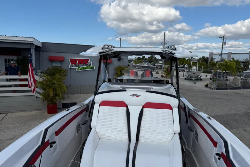 Slide: The Image of 2025 Sunsation 32 CCX boat at WME Watersports, featuring sleek white and red seating. - 20