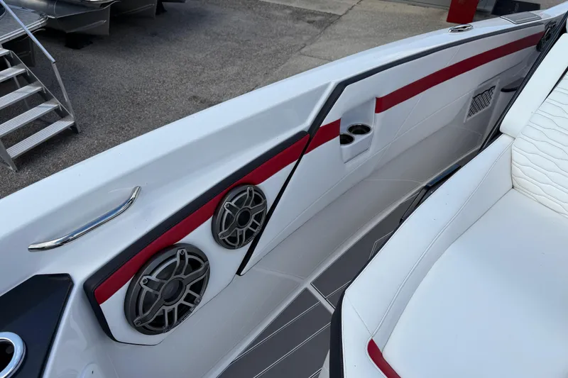 Slide: The Image of 2025 Sunsation 32 CCX boat interior with speakers and seating, featuring red and white accents. - 21