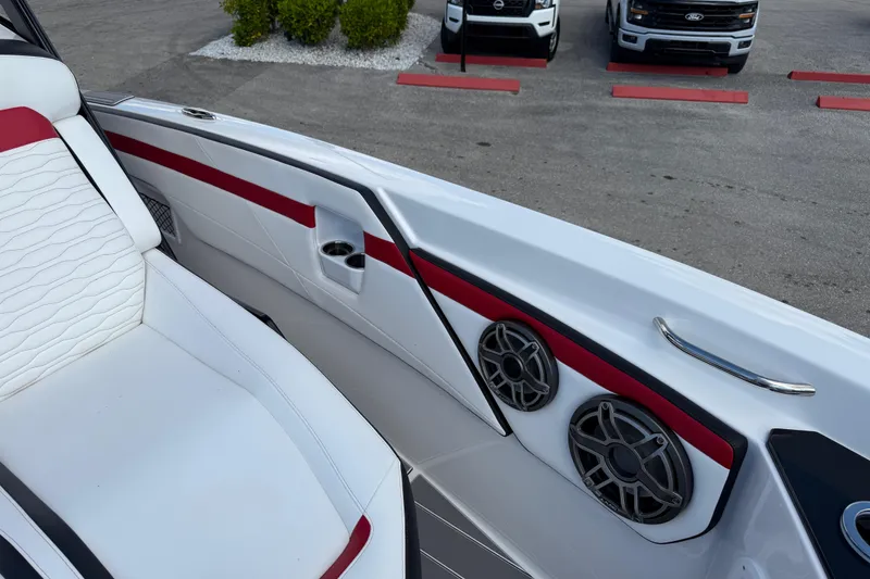 Slide: The Image of 2025 Sunsation 32 CCX boat interior with white and red seating, speakers, and sleek design. - 22