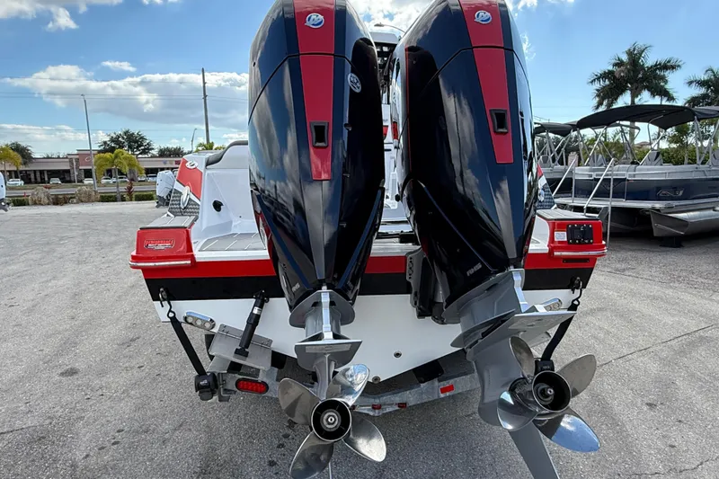 Slide: The Image of 2025 Sunsation 32 CCX boat with dual outboard engines, parked outdoors. - 8