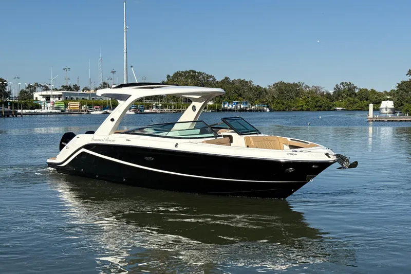 The Image of 2021 Sea Ray SLX 310 Outboard boat cruising on a calm lake. - 0