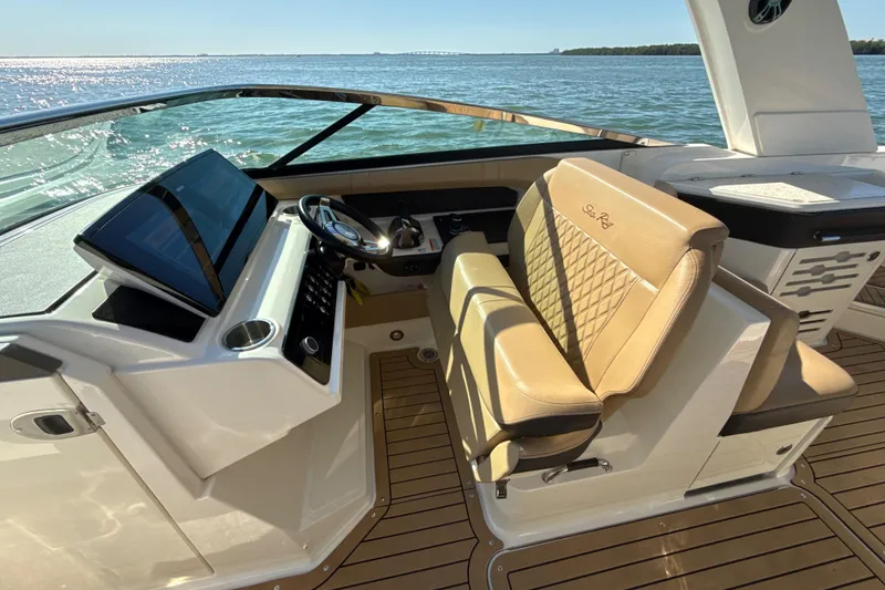 Slide: The Image of 2021 Sea Ray SLX 310 Outboard helm with luxurious seating and modern dashboard. - 12