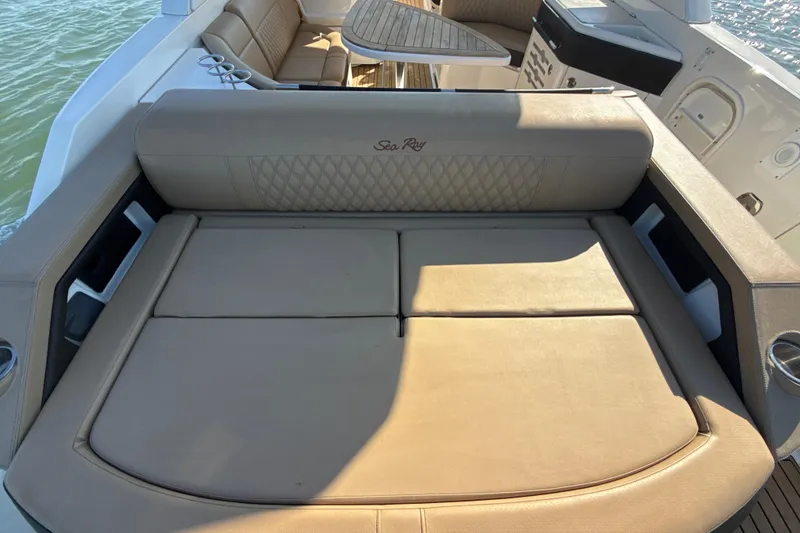 Slide: The Image of 2021 Sea Ray SLX 310 Outboard boat interior with luxurious seating and table. - 20