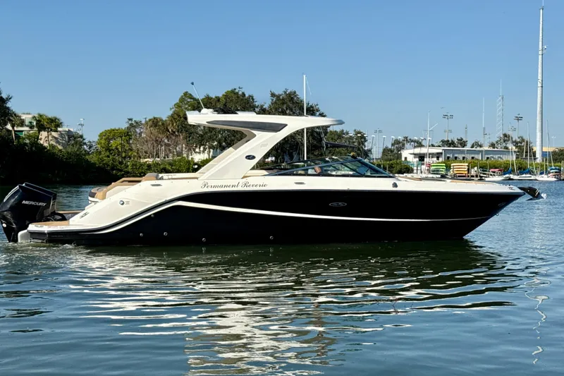 Slide: The Image of 2021 Sea Ray SLX 310 Outboard boat on calm water, side view. - 22