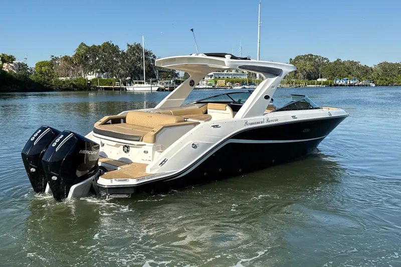 Slide: The Image of 2021 Sea Ray SLX 310 Outboard boat cruising on a calm lake. - 23