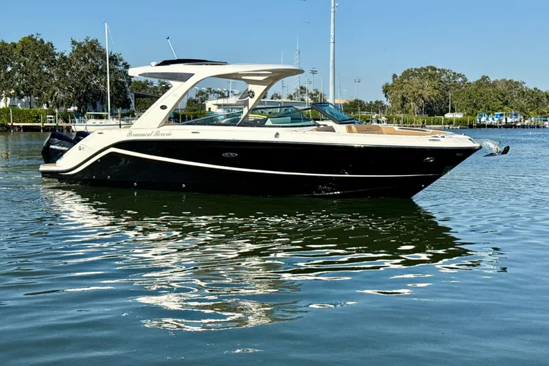Slide: The Image of 2021 Sea Ray SLX 310 Outboard boat on calm water, sunny day. - 25