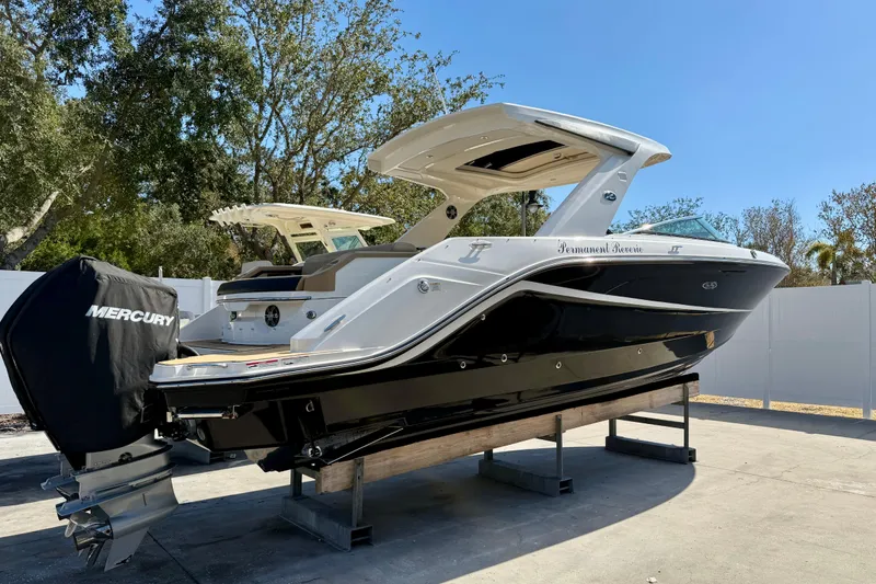 Slide: The Image of 2021 Sea Ray SLX 310 Outboard boat with Mercury engine on display outdoors. - 26