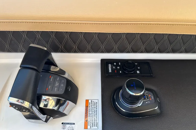 Slide: The Image of Control panel of 2021 Sea Ray SLX 310 Outboard with joystick and throttle. - 28