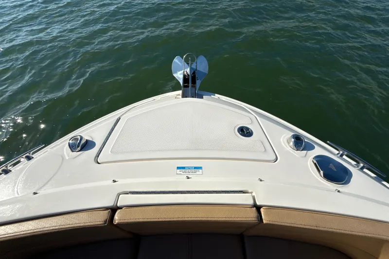 Slide: The Image of 2021 Sea Ray SLX 310 Outboard boat bow on water, showcasing deck and anchor. - 29