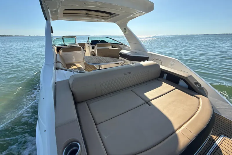 Slide: The Image of 2021 Sea Ray SLX 310 Outboard luxury boat interior on open water. - 3