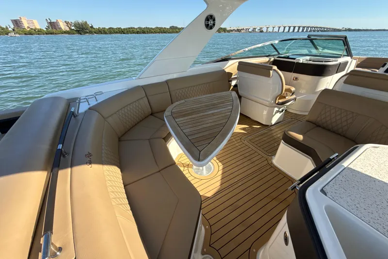 Slide: The Image of 2021 Sea Ray SLX 310 Outboard interior with luxurious seating and elegant design on the water. - 4