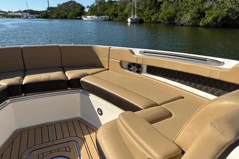Slide: The Image of Luxurious seating on 2021 Sea Ray SLX 310 Outboard boat, cruising on a serene waterway. - 7