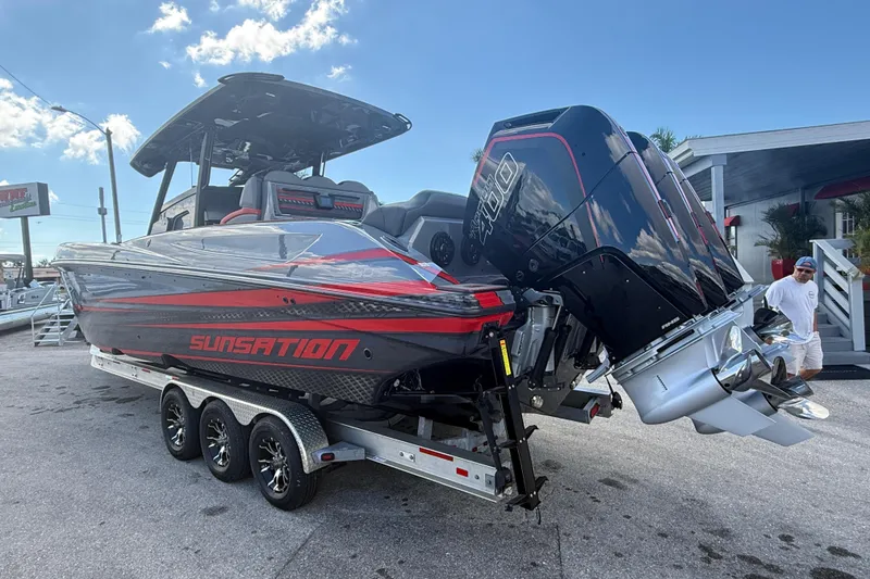 Slide: The Image of 2026 Sunsation 34 CCX boat with powerful engines on a trailer, ready for adventure. - 11