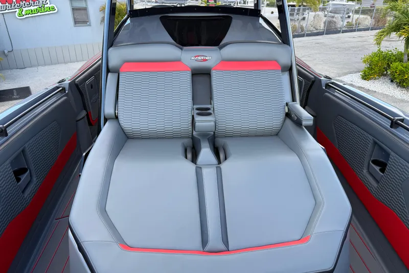 Slide: The Image of 2026 Sunsation 34 CCX boat interior with gray and red seating, featuring cup holders. - 17