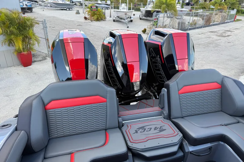 Slide: The Image of 2026 Sunsation 34 CCX boat with triple outboard engines and stylish seating. - 23