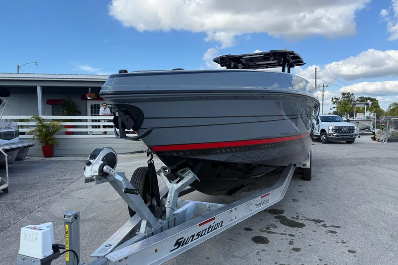 Slide: The Image of 2026 Sunsation 34 CCX boat on trailer, parked outdoors under a blue sky. - 4