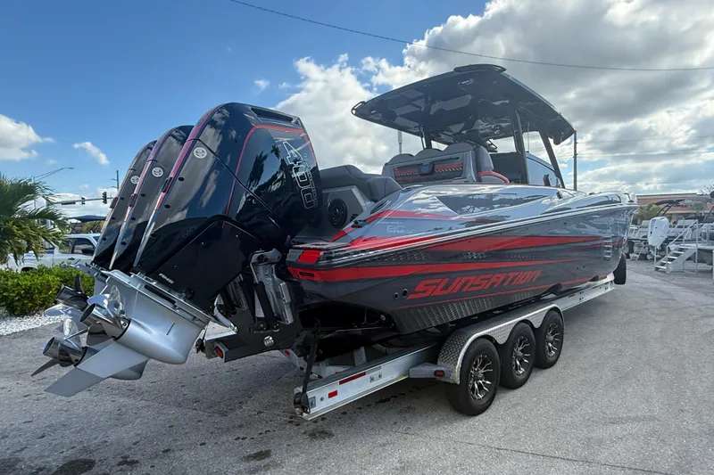 Slide: The Image of 2026 Sunsation 34 CCX boat on trailer, featuring powerful outboard engines and sleek design. - 7
