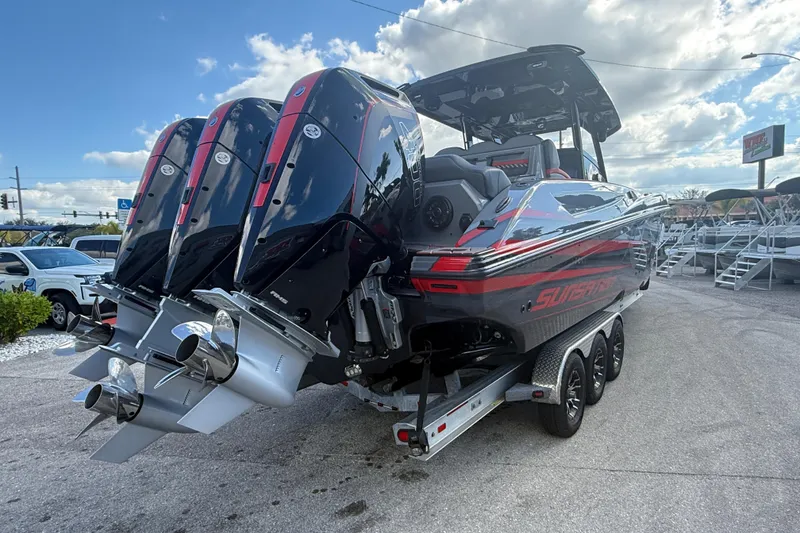 Slide: The Image of 2026 Sunsation 34 CCX boat with triple outboard engines on a trailer. - 8