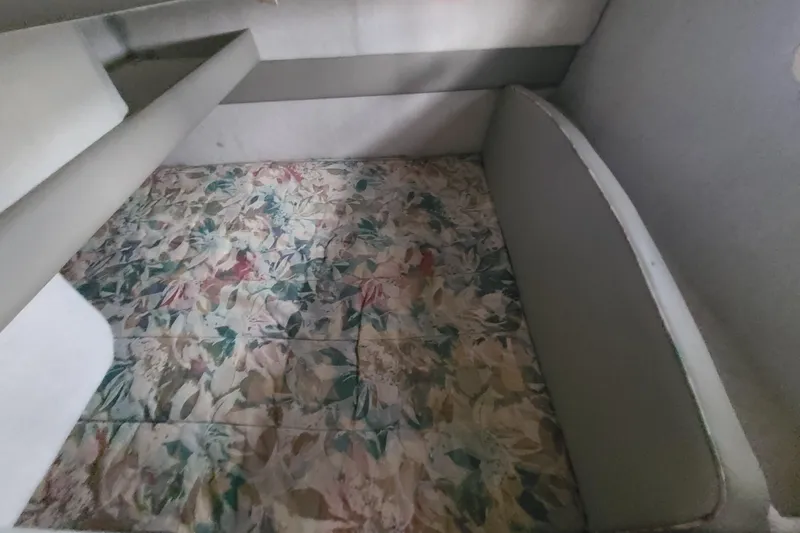 Slide: The Image of 1997 Bayliner 3255 Avanti cabin interior with floral-patterned bedding. - 12