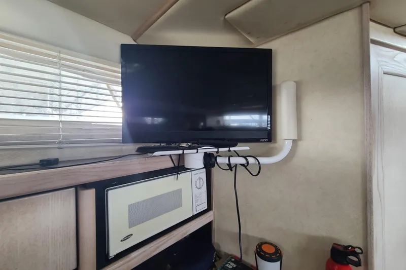 Slide: The Image of Interior of 1997 Bayliner 3255 Avanti with mounted TV and microwave. - 14