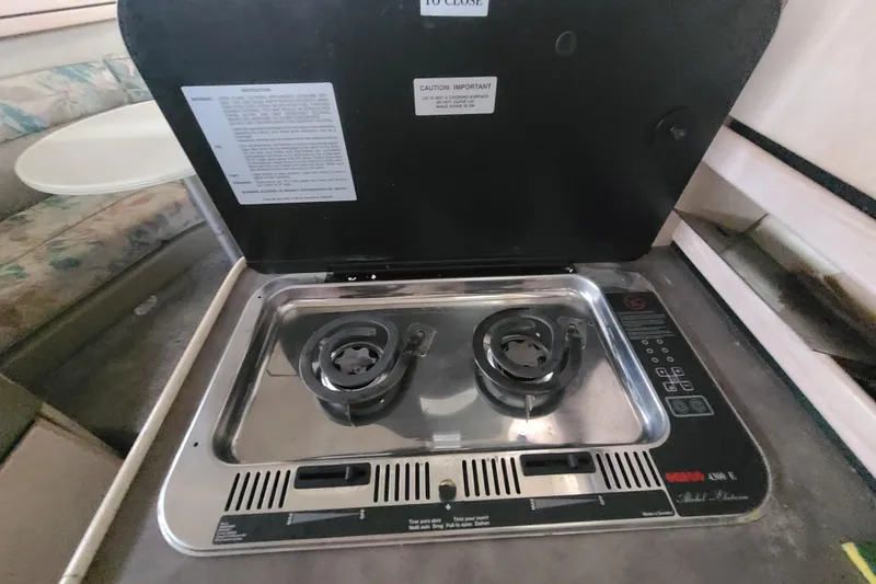 Slide: The Image of 1997 Bayliner 3255 Avanti boat interior with a compact two-burner stove. - 16