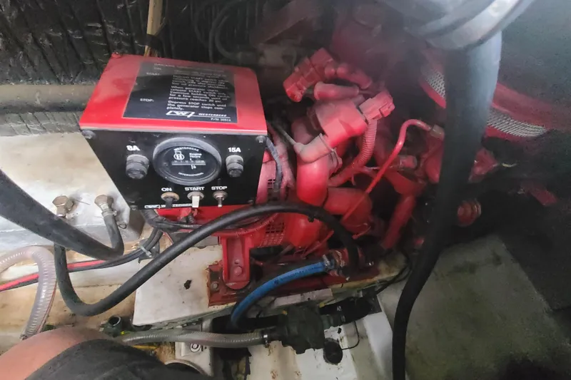 Slide: The Image of Engine compartment of a 1997 Bayliner 3255 Avanti boat with red mechanical components. - 18