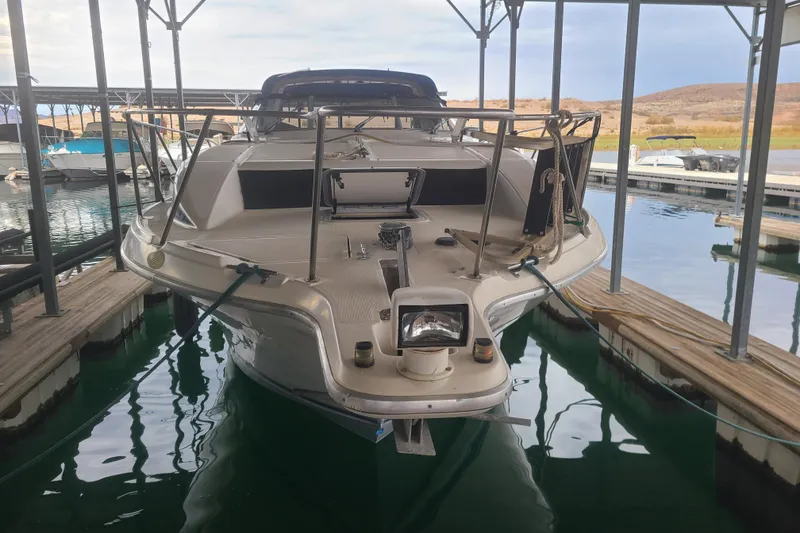 Slide: The Image of 1997 Bayliner 3255 Avanti docked in a marina, front view. - 3