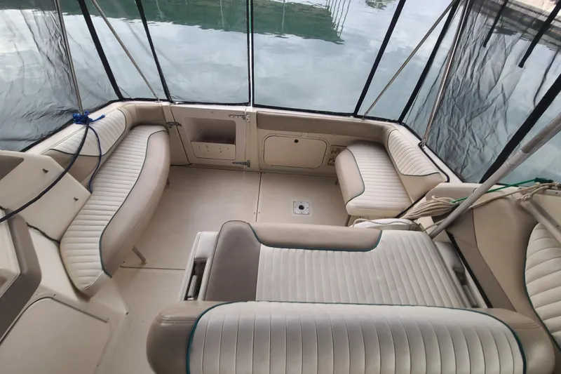 Slide: The Image of 1997 Bayliner 3255 Avanti boat interior with cushioned seating and enclosed canopy. - 6
