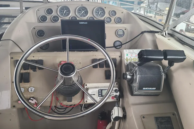 Slide: The Image of 1997 Bayliner 3255 Avanti helm with steering wheel, gauges, and controls. - 7