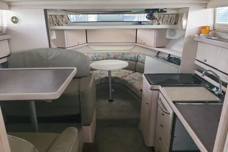 Slide: The Image of Interior of 1997 Bayliner 3255 Avanti boat with seating, table, and kitchenette. - 9