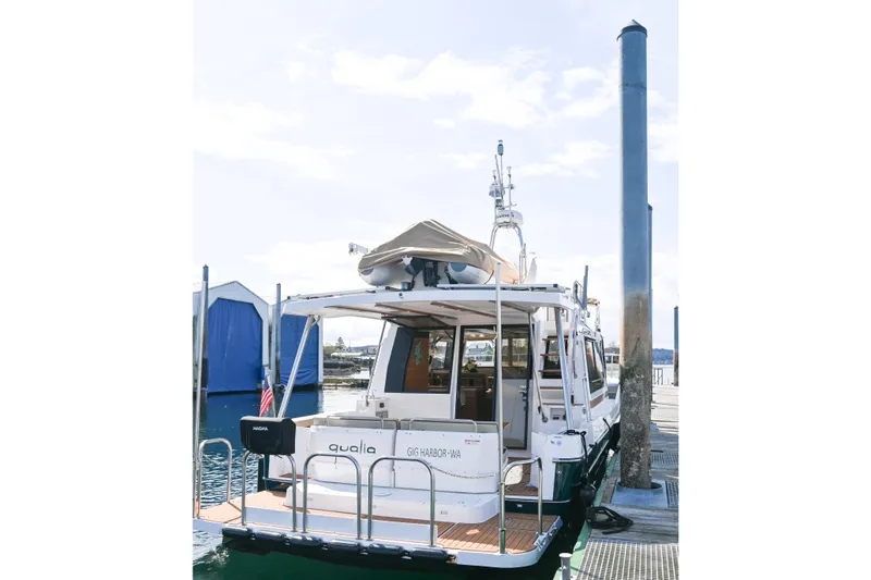Slide: The Image of 2022 Ranger Tugs R-43 CB docked at marina, rear view with clear sky. - 10
